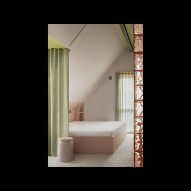 At the top of Salongsgatan lies the master bedroom, a haven of serenity despite its vibrant palette. Soft pinks and soothing greens converge, crafting a tranquil space that’s as colorful as it is calming.